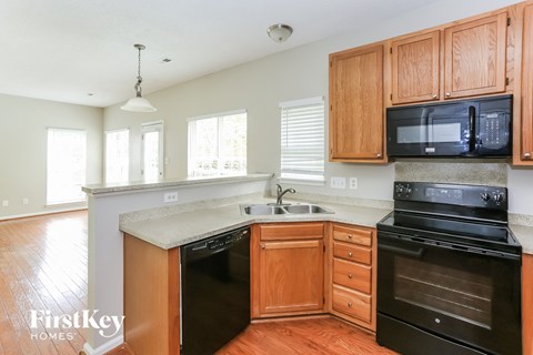 a kitchen with black appliances and wooden cabinets
