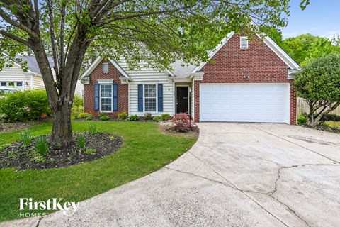 a house with a white garage door and a driveway