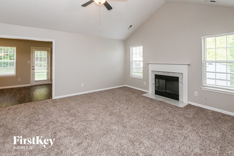 the living room of an empty house with a fireplace