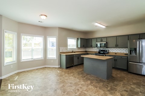 a kitchen with stainless steel appliances and a large counter top