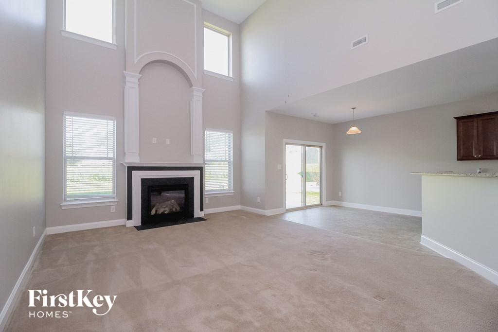 the living room of a new home with a fireplace
