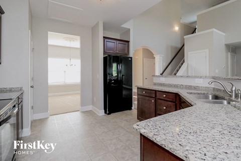 a large kitchen with granite counter tops and stainless steel appliances