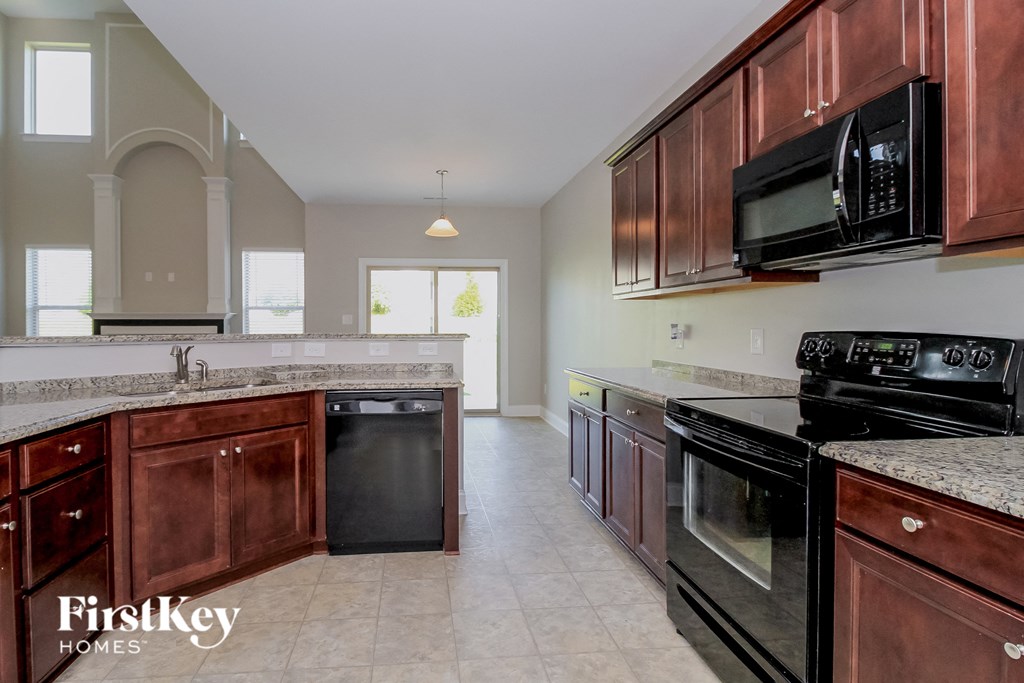a kitchen with wooden cabinets and black appliances