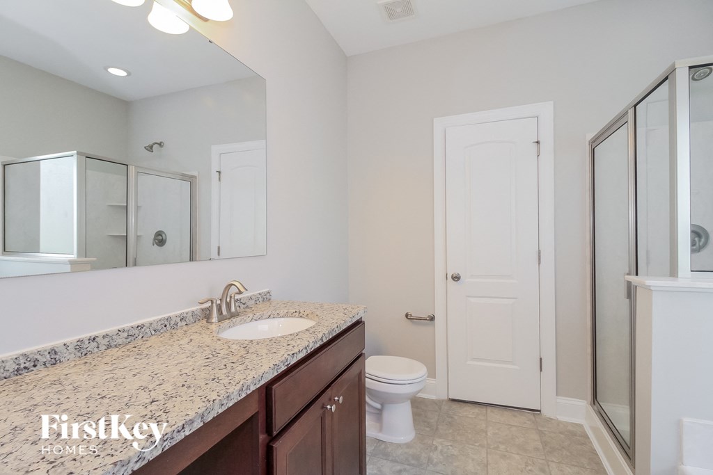 a bathroom with a sink and a toilet and a shower