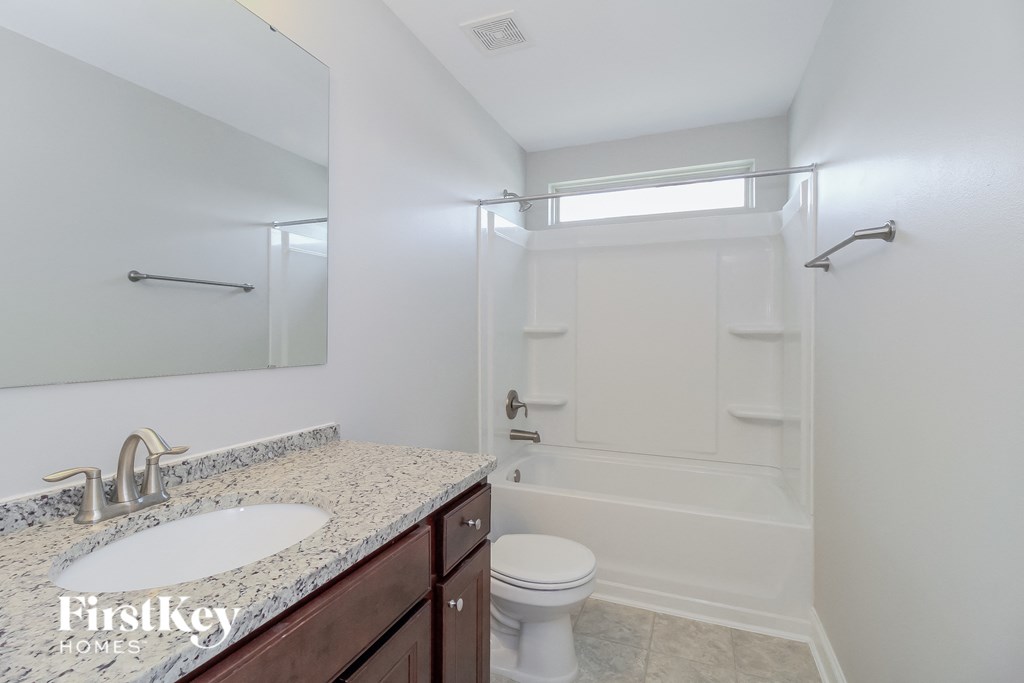 a bathroom with a sink and a shower and a toilet