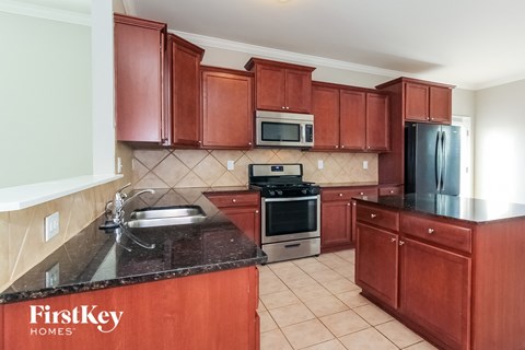 a kitchen with wooden cabinets and granite counter tops