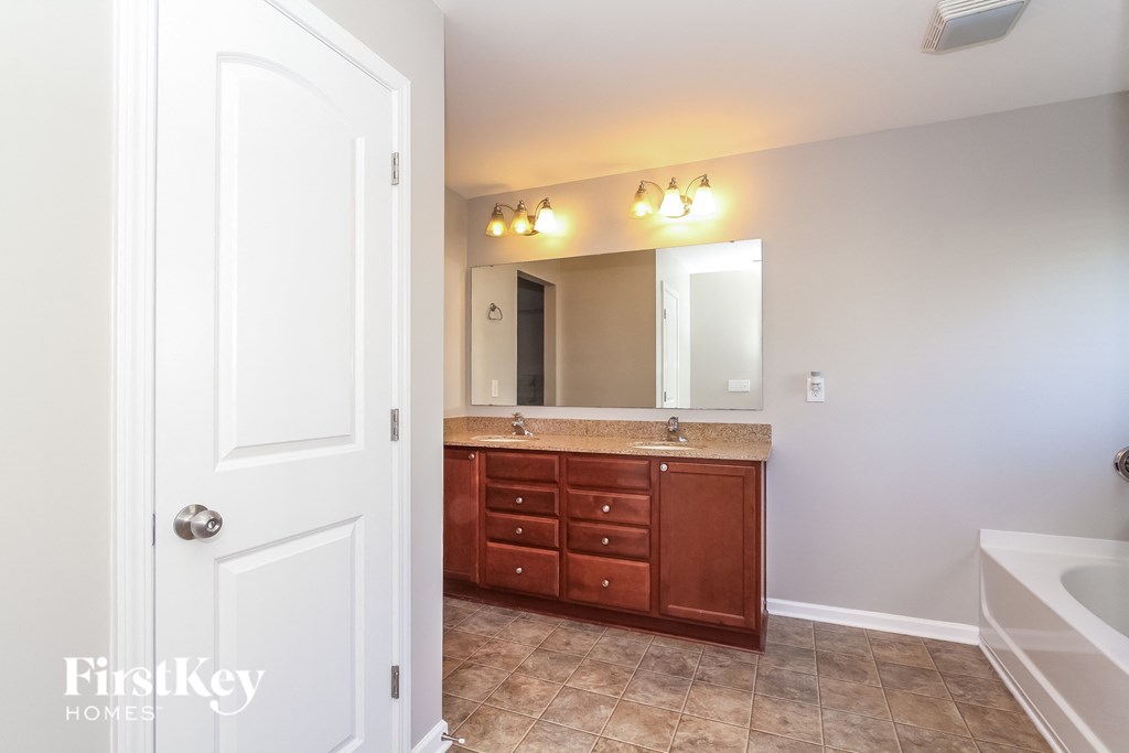 a bathroom with a vanity and a mirror and a sink