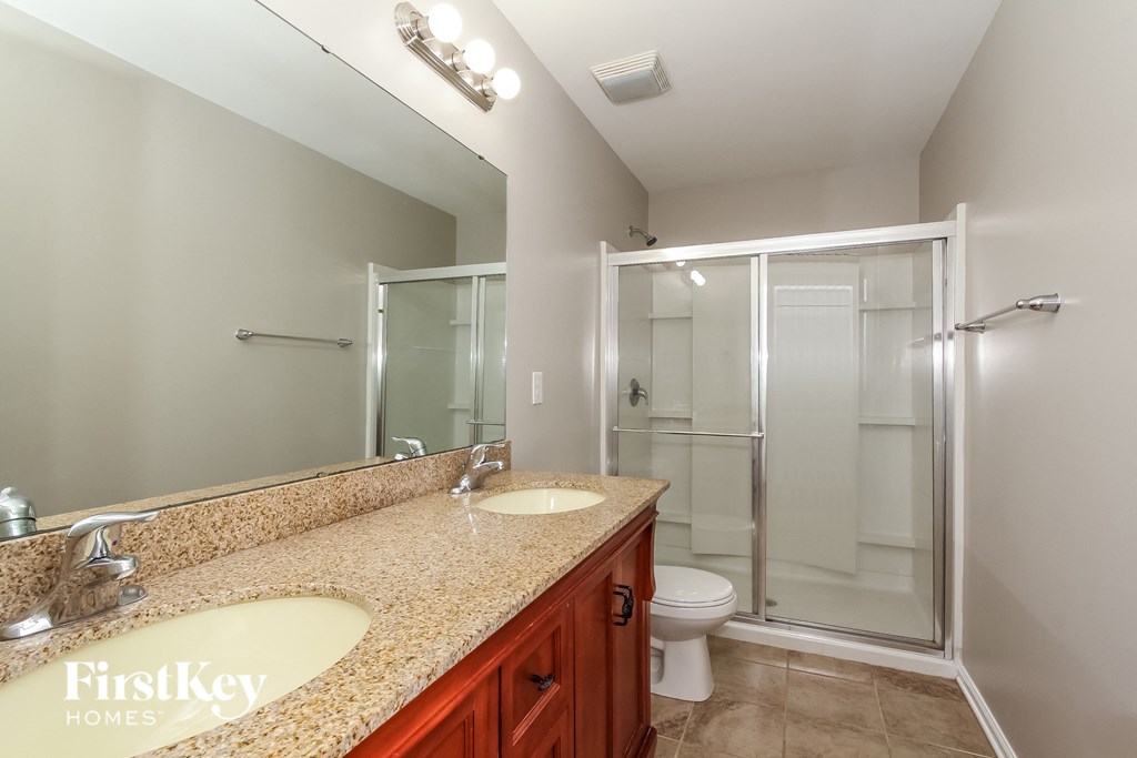a bathroom with a sink and a shower and a toilet