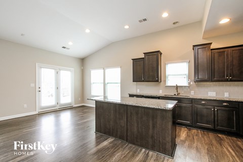 A kitchen with dark wood cabinets and a white countertop.