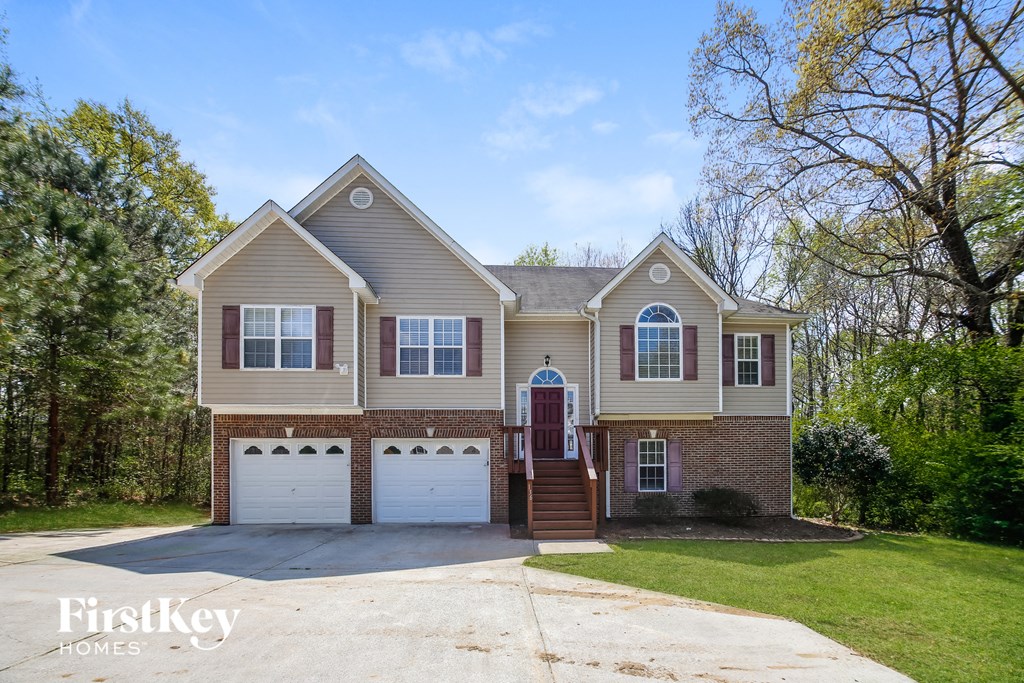 A two-story house with a garage is for sale.