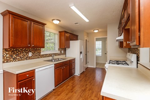 A kitchen with wooden cabinets and a white countertop.