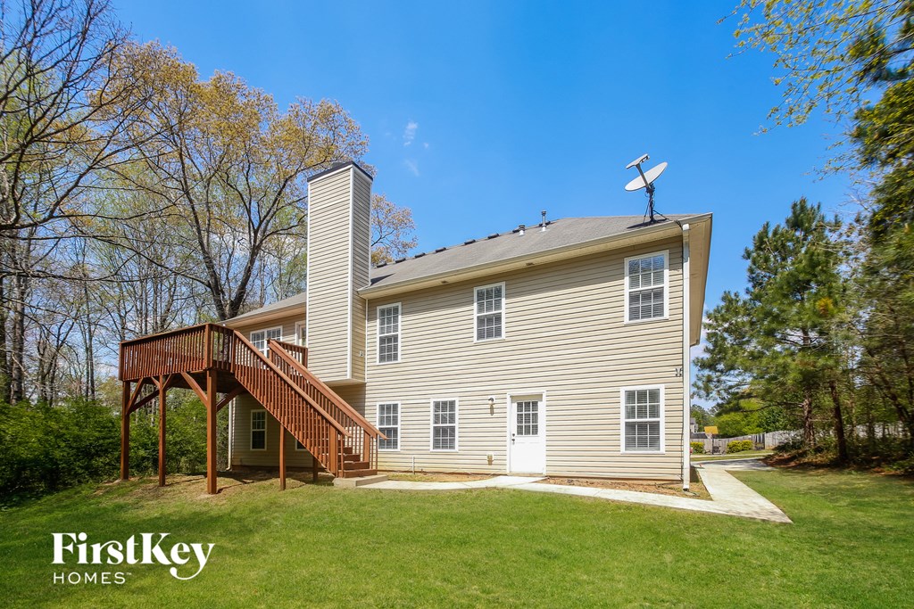 A house with a white door and a satellite dish on the roof.