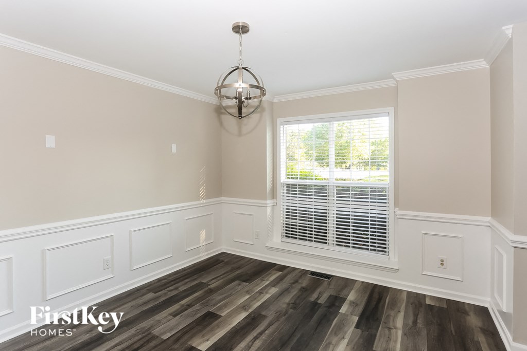 a dining room with wood flooring and a window