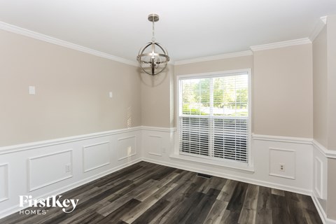 a dining room with wood flooring and a window