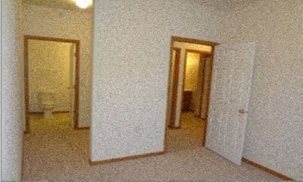 a room with a mirror and two doors in it