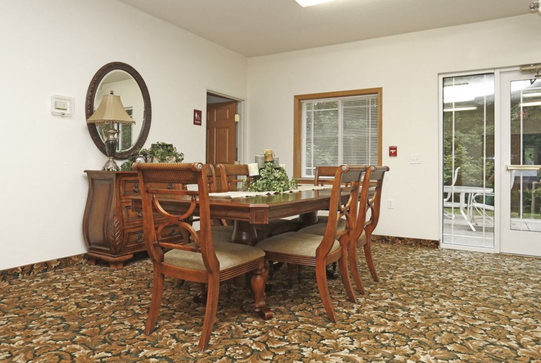 a dining room with a table and chairs