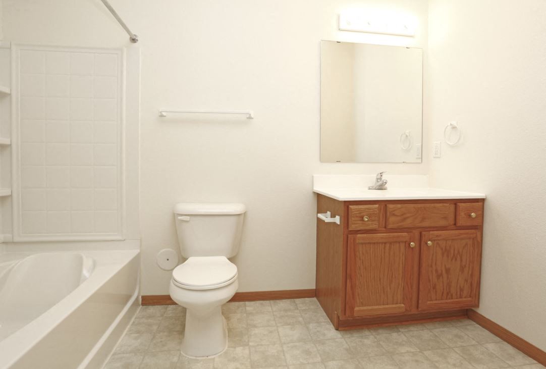 a bathroom with a toilet and a sink and a bath tub