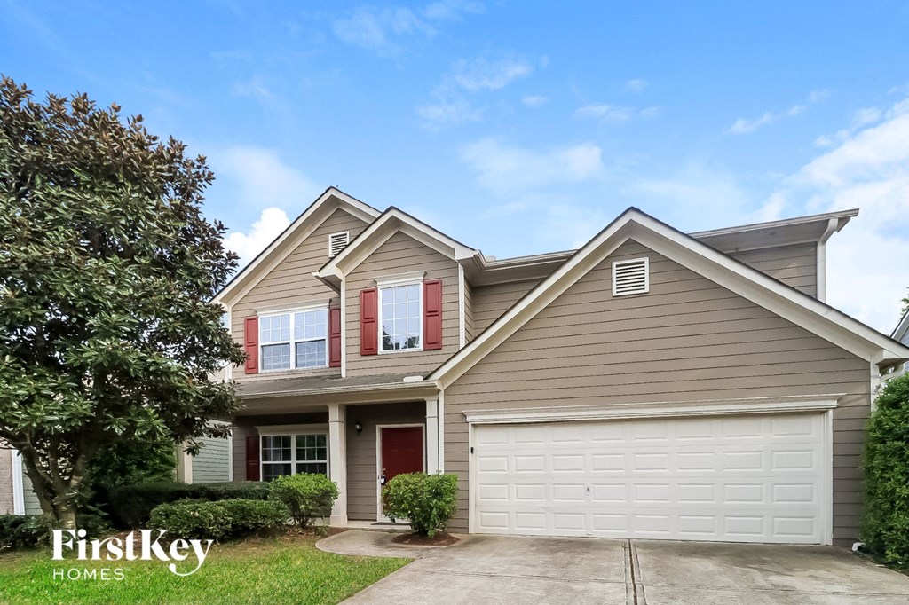 A two-story house with a garage is for sale.