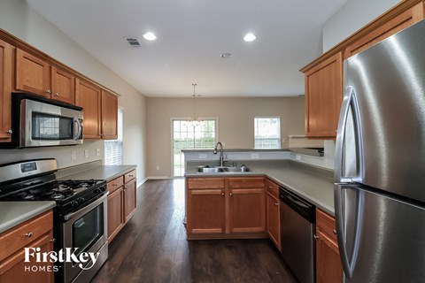 A kitchen with wooden cabinets and stainless steel appliances.
