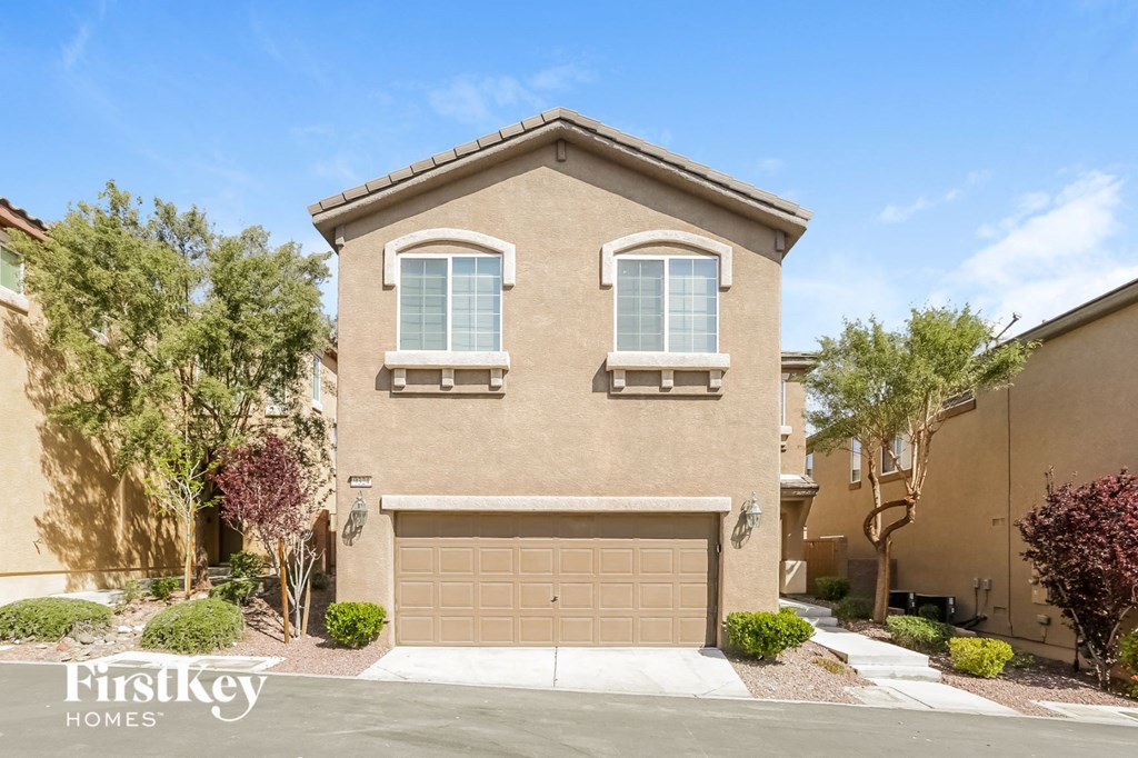 a house with a garage door in front of it