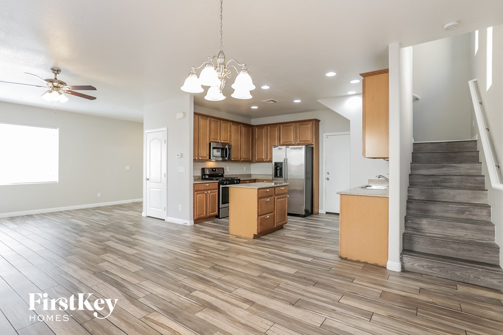 the kitchen is open to the living room and dining room