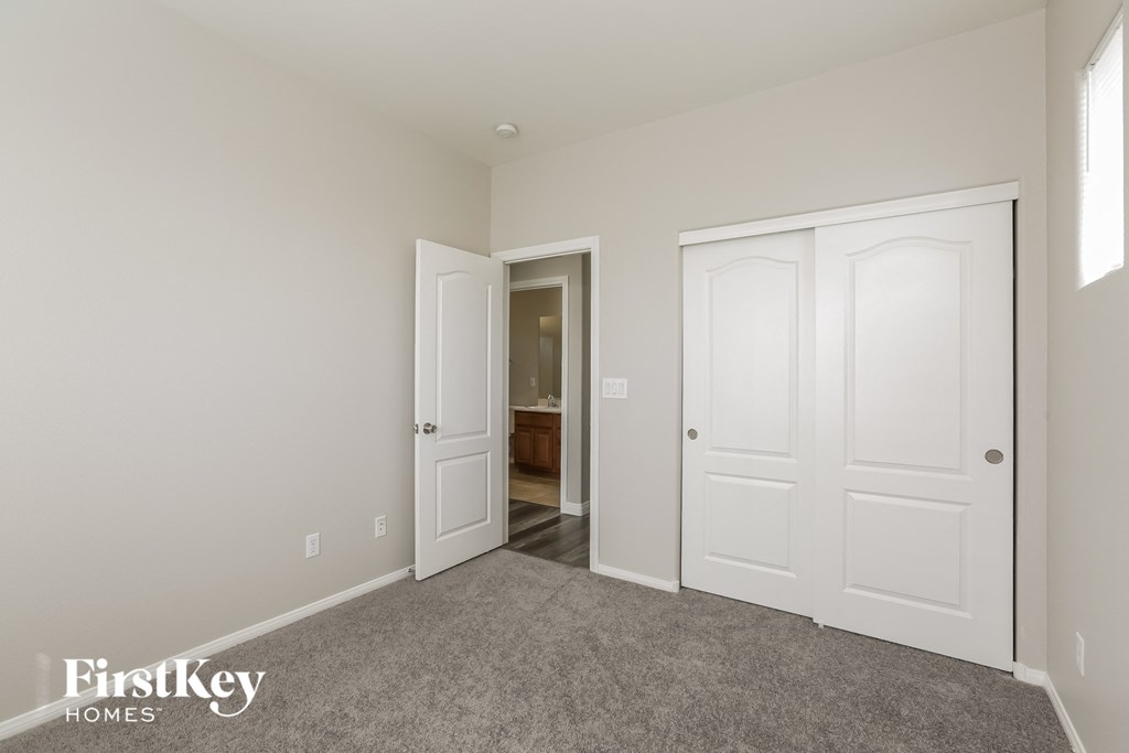 a bedroom with two closets and a door to a bathroom