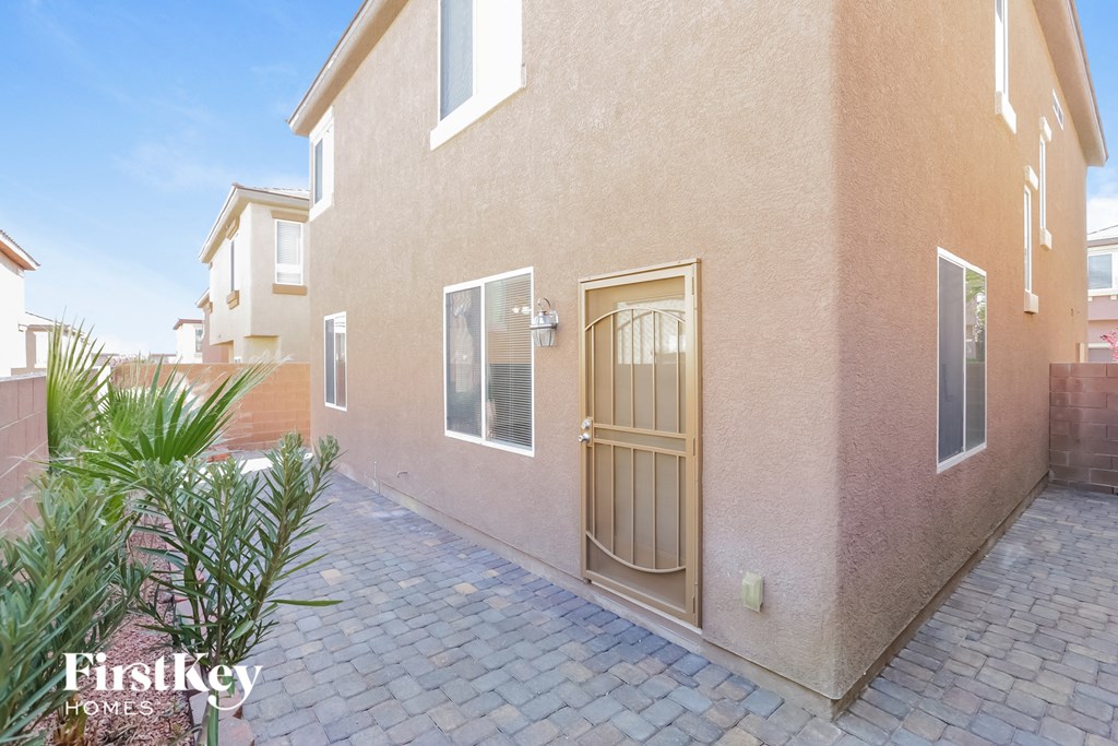 a side view of a house with a patio and a door