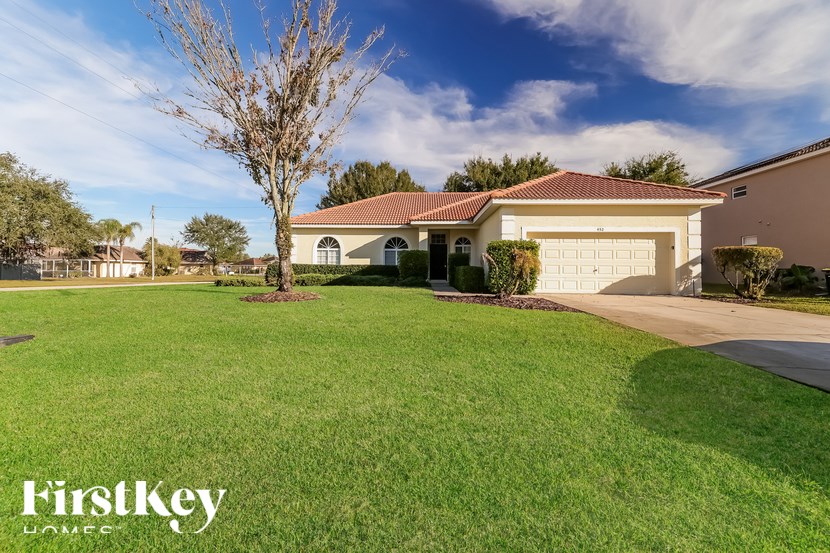A house with a well-maintained lawn and a clear sky.
