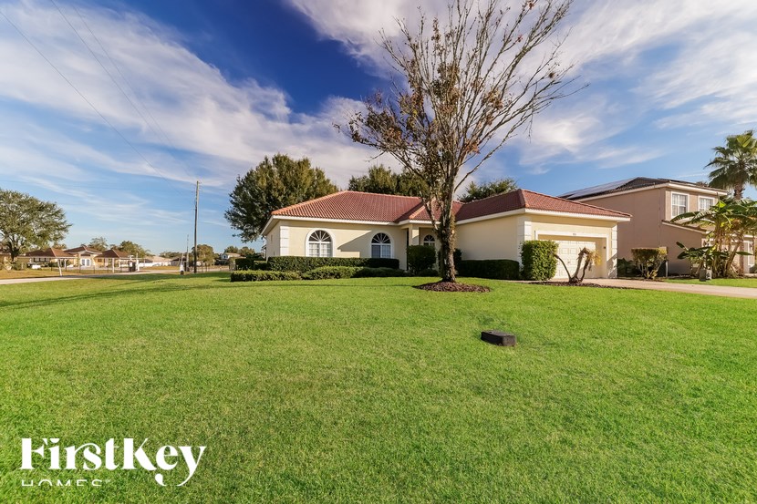 A large house with a lawn in front of it.