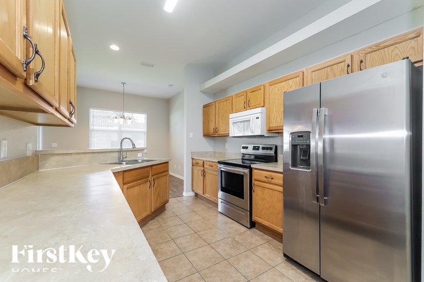 A kitchen with wooden cabinets and stainless steel appliances.