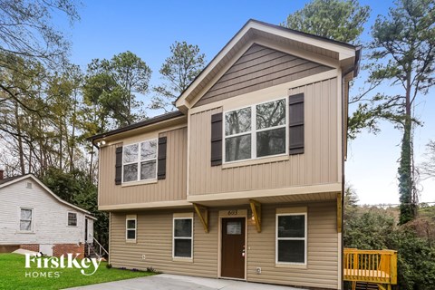 A two-story house with a garage is for sale.