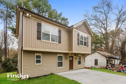 A two-story house with a garage is for sale.