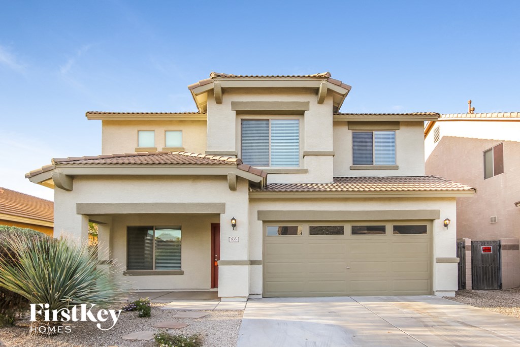 a house with a garage door in front of it