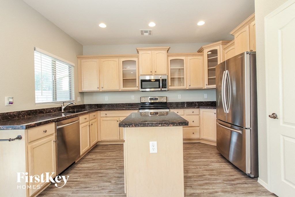 a kitchen with wooden cabinets and stainless steel appliances