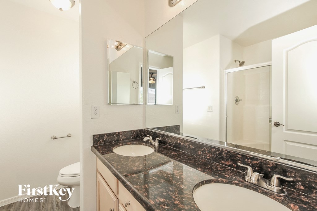 a bathroom with two sinks and a large mirror