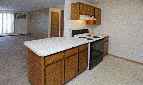 a kitchen with a white counter top and a stove