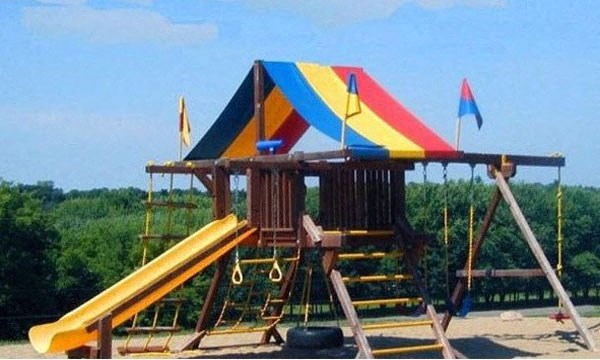 a playground with a slide and a tent