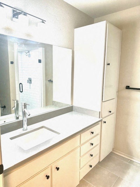 A white bathroom with a sink, mirror, and cabinets.
