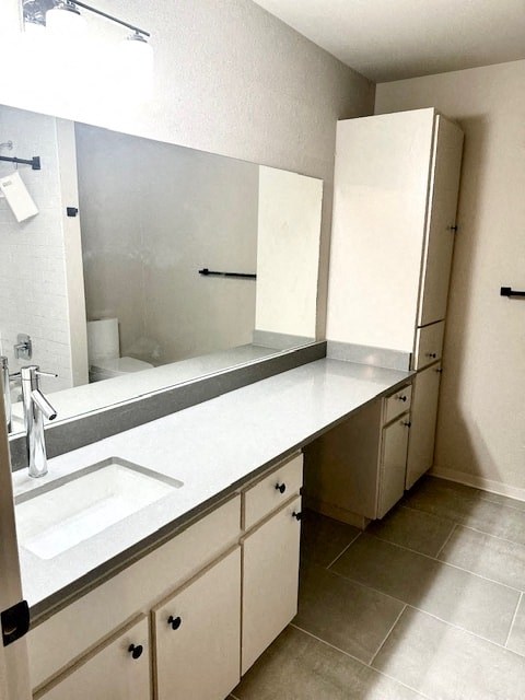 A white sink is in a white counter top in a white bathroom.