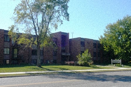 a large brick building with trees in front of it
