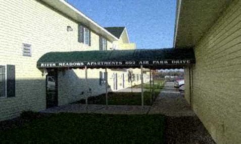 a building with a sign that says allied nation apartments and an air park drive