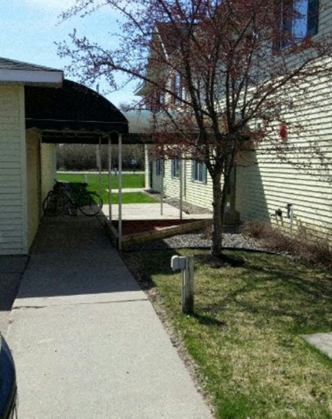 a covered walkway in front of a house