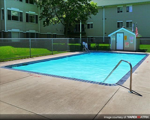 a swimming pool in front of an apartment building