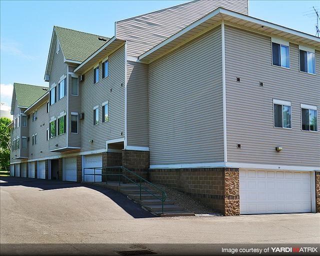 a group of houses with stairs and a driveway