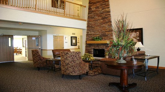 a living room with a fireplace and a table and chairs