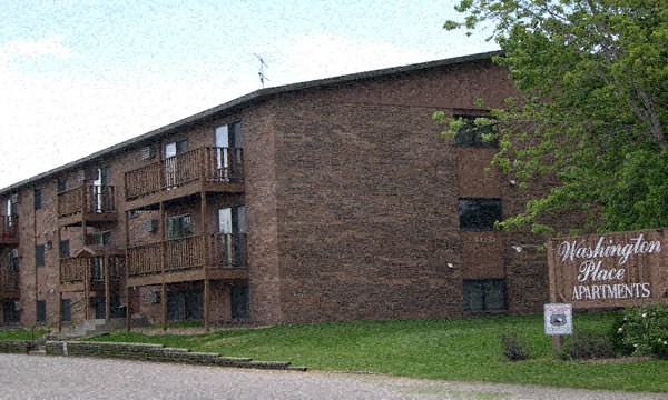a large brick building with a sign in front of it