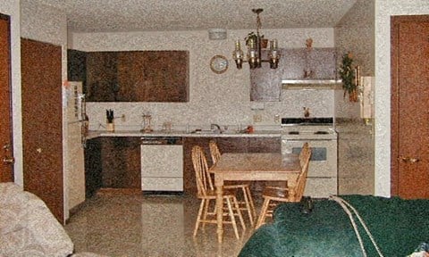 a kitchen with a dining table and chairs