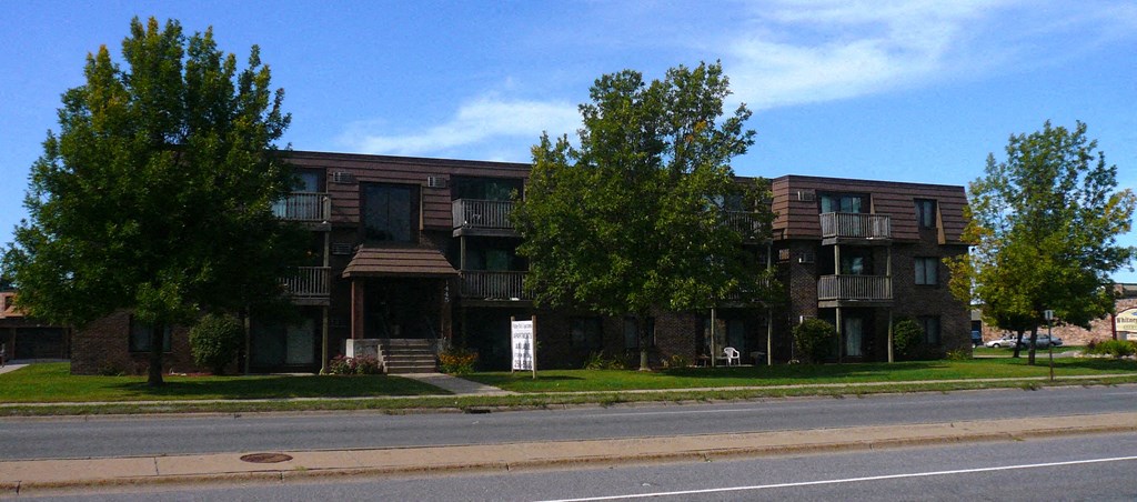 an apartment building on the side of a street