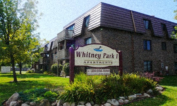 a sign apartments in front of a building