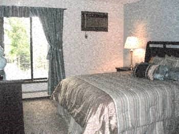 a bedroom with a bed and a large window